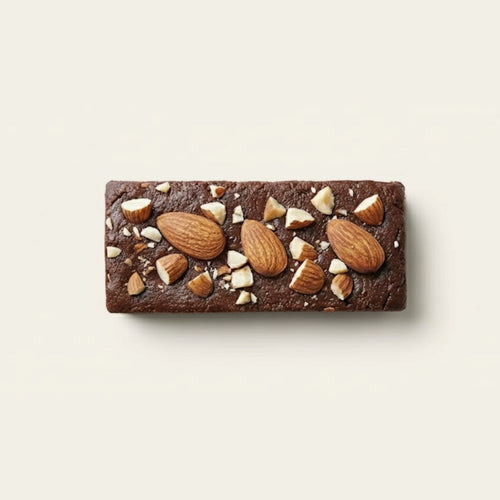 Chocolate protein bar with nuts on a light beige background