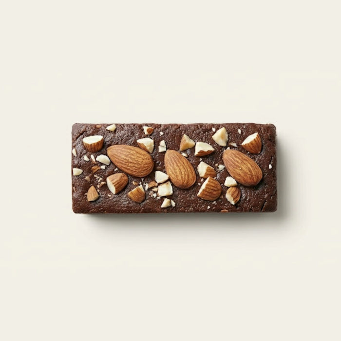 Chocolate protein bar with nuts on a light beige background