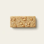 Peanut protein bar with nuts on a light beige background