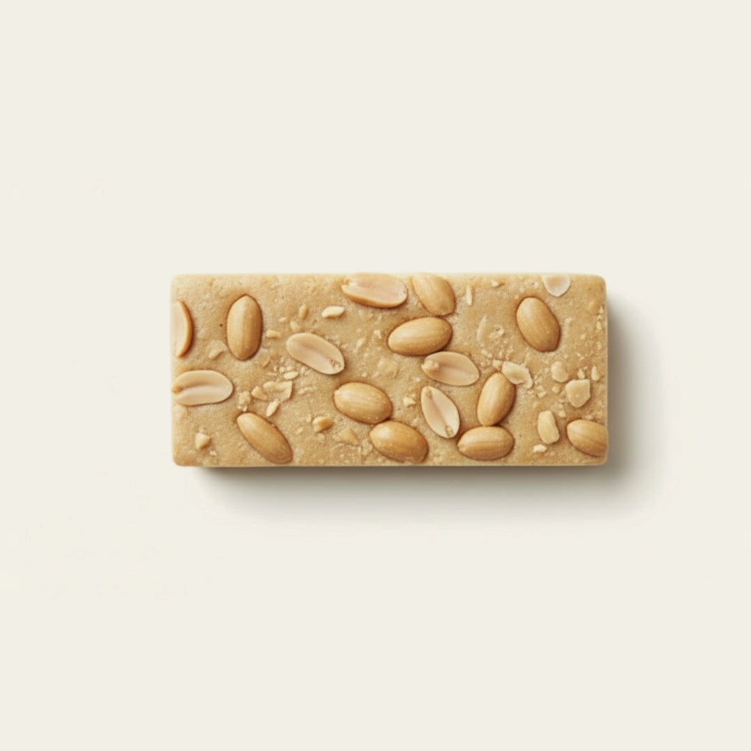 Peanut protein bar with nuts on a light beige background