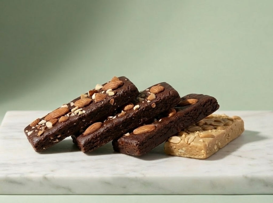 Protein bars with nuts on a marble surface against a green background